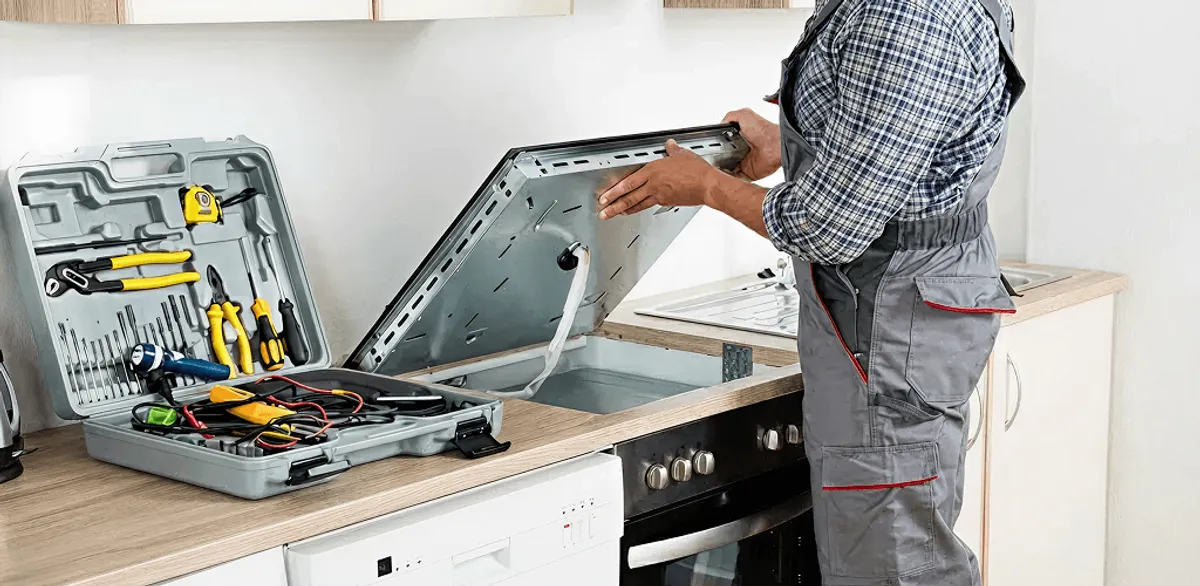 Handyman repairing a cooktop and checking wiring connections in Akron, OH