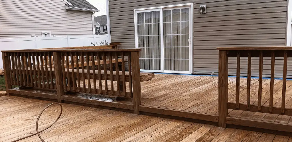 Deck sealing service protecting a backyard wood deck and railings in Akron, OH