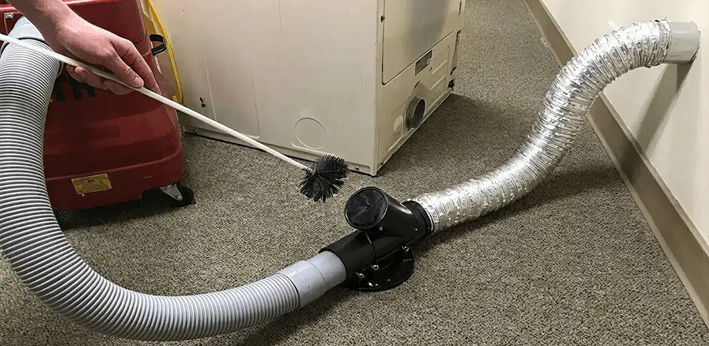Dryer vent cleaning service removing lint from a dryer duct connection in Akron, OH