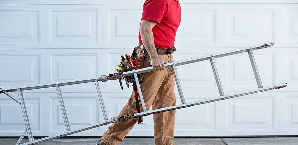 Garage door repair technician arriving with tools and ladder in Akron, OH