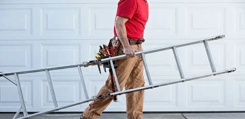 Garage door repair technician arriving with tools and ladder in Akron, OH