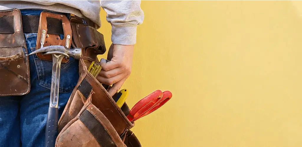 Handyman with tool belt ready for home repairs and maintenance in Akron, OH