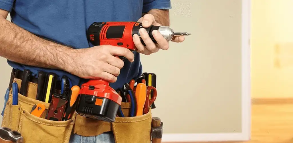Handyman holding a power drill for home repairs and installations in Akron, OH