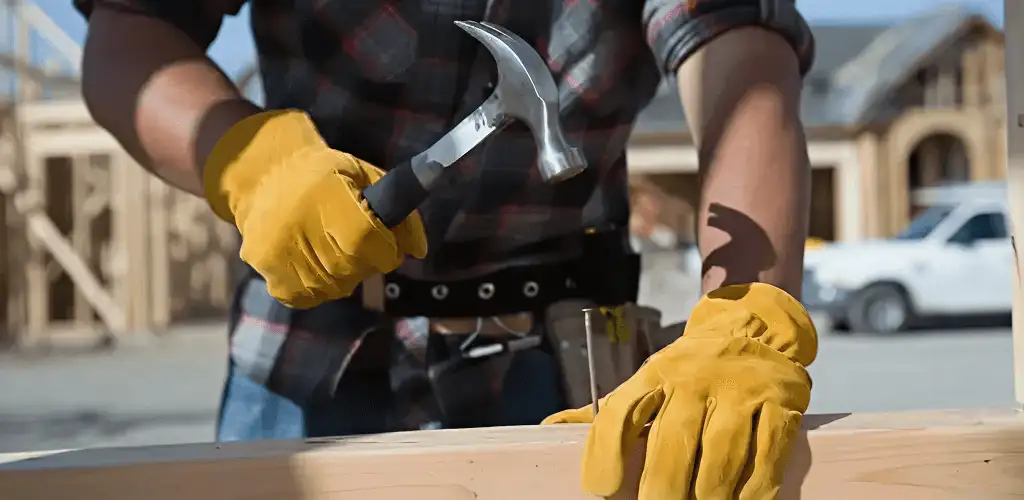 Handyman fixing wood trim with a hammer for home repairs in Akron, OH
